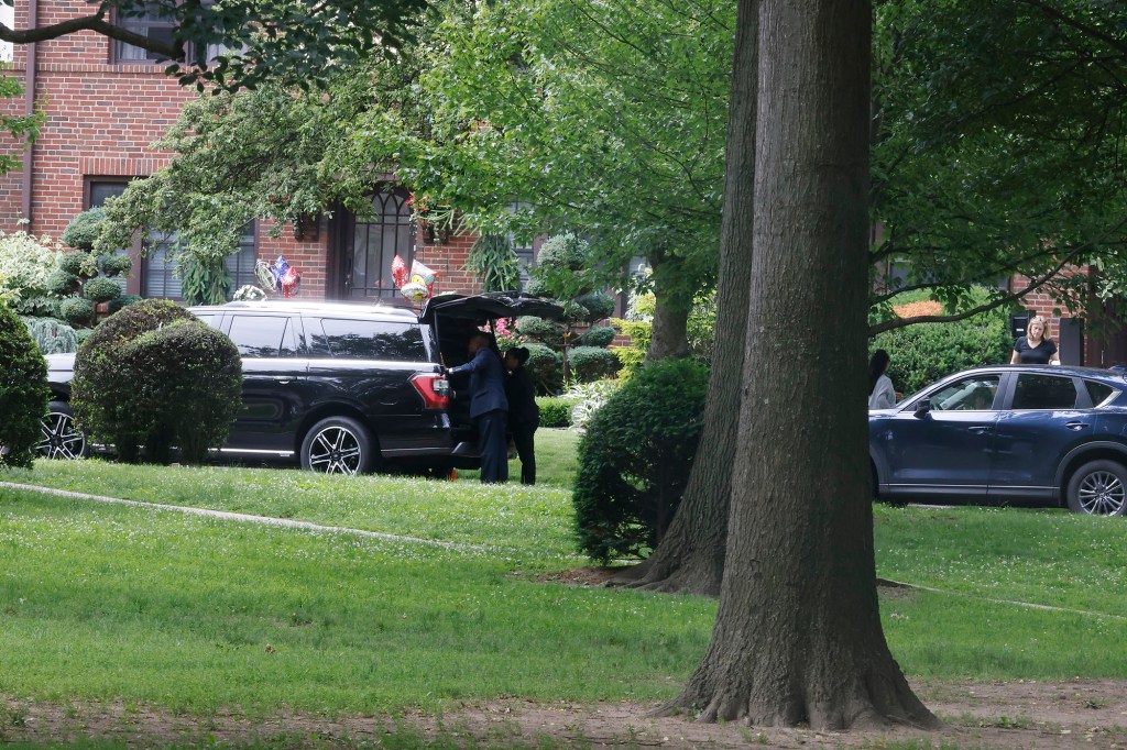 Security detail loading/unloading items from SUV