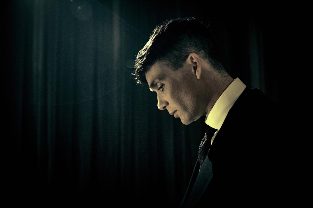 Tommy Shelby (Cillian Murphy) in profile, looking down.