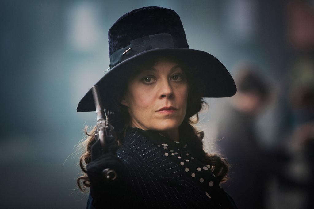 The late Helen McCrory as Polly wearing a hat looking stern in "Peaky Blinders."