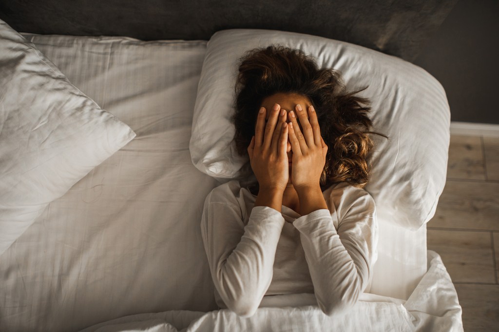 Sad and lonely girl in bedroom. Insomnia and psychological issues. Breakup with boyfriend. Conceptual of bad condition of broken hearted, sadness, loneliness or depress woman.