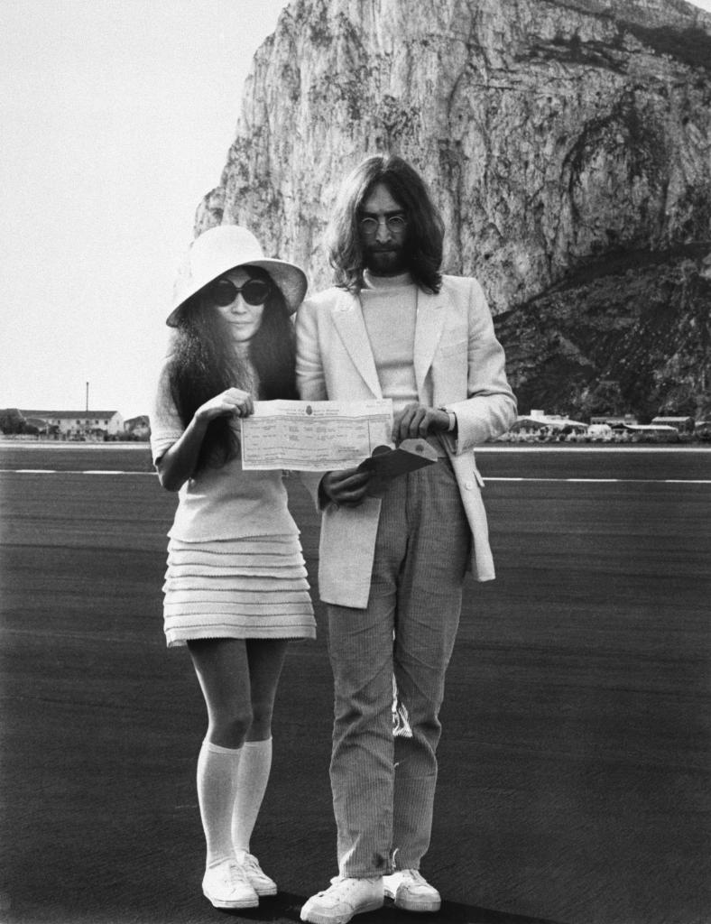 Beatle John Lennon and his bride, Japanese-born Yoko Ono hold the marriage certificate following their registry office wedding here on March 21st. Providing the background in the picture is the famous Rock of Gibraltar. This was Lennon's second marriage and 36-year-old Yoko's third.