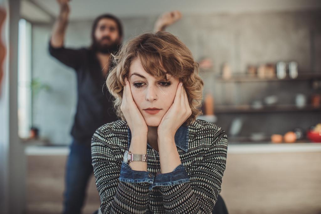 Furious couple arguing in the kitchen.