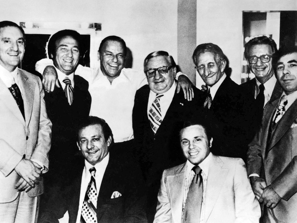 Ol' Blue Eyes at the Westchester Premier Theatre in 1976. Top row: Paul Castellano, Gregory De Palma, Frank Sinatra, Thomas Marson, Carlo Gambino, Aladena 'Jimmy' Fratianno, Salvatore Spatola. Bottom row: Joe Gambino and Richard Fusco