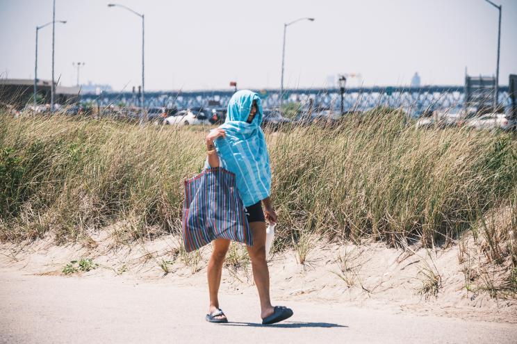 People gather at Jacob Riis beach in Queens, New York, on a 95 degree day.