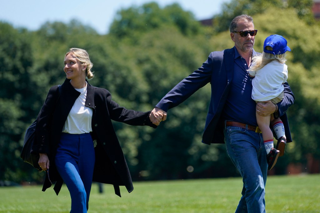 Melissa Cohen Biden walks with her husband Hunter Biden and their son Beau as they arrive with President Joe Biden at Ft. McNair aboard Marine One after spending the weekend at Camp David, Monday, July 4, 2022, in Washington.