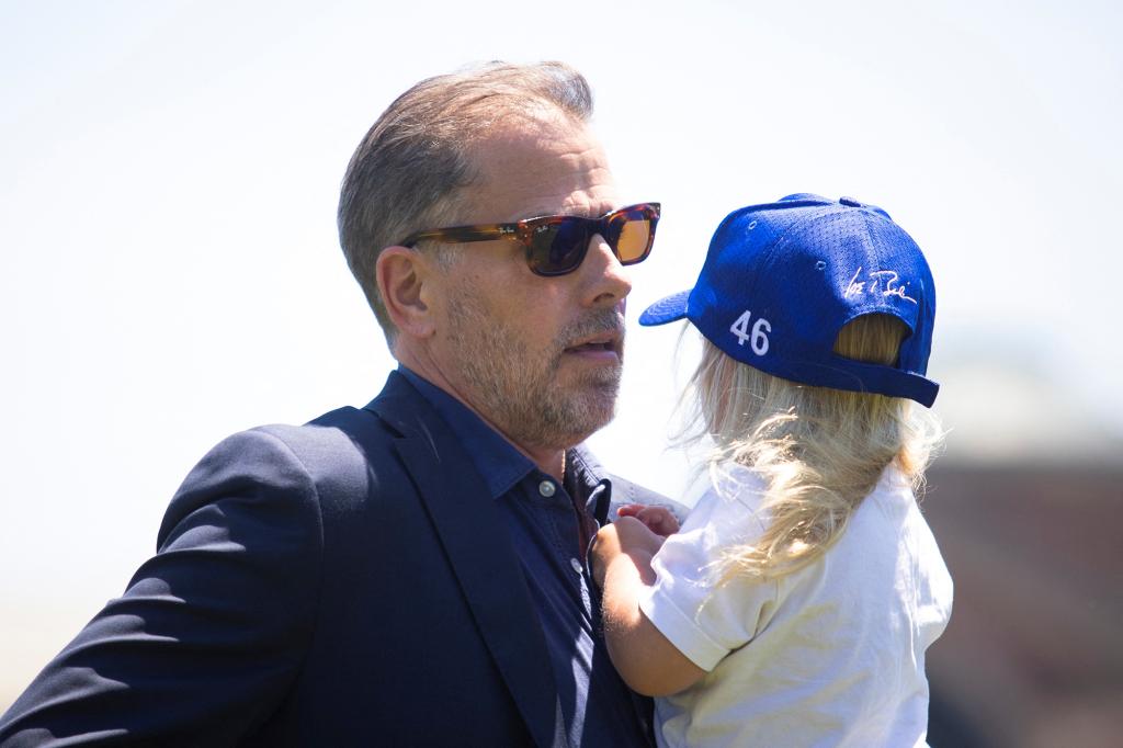 Hunter Biden, son of U.S. President Joe Biden, carries his son Beau, after exiting Marine One with the president and first lady at Fort McNair in Washington, U.S., July 4, 2022.