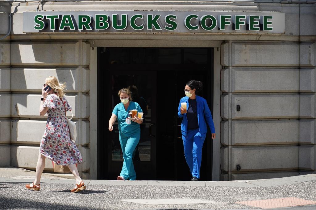 Customers exits Starbucks Coffee located at 10th Street and Chestnut Street in Center City Philadelphia that will be closing due to safety concerns according to a company announcement.