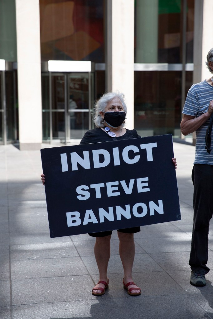 A protester calls for Steve Bannon's indictment.