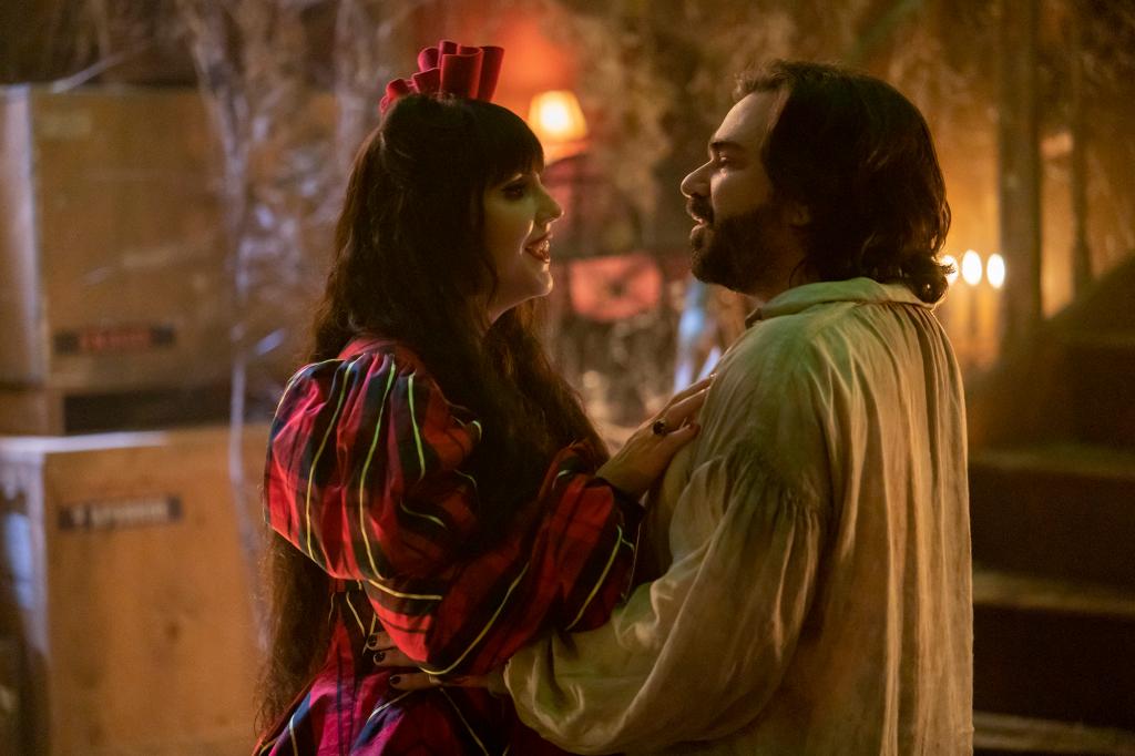 Photo showing Natasia Demetriou and Matt Berry as Nadja and Laszlo. They're facing each other and embracing and are both smiling.