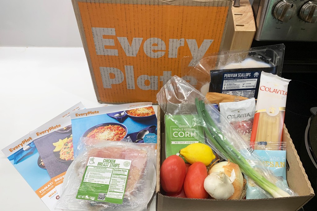 A box of EveryPlate food with ingredients on a white counter