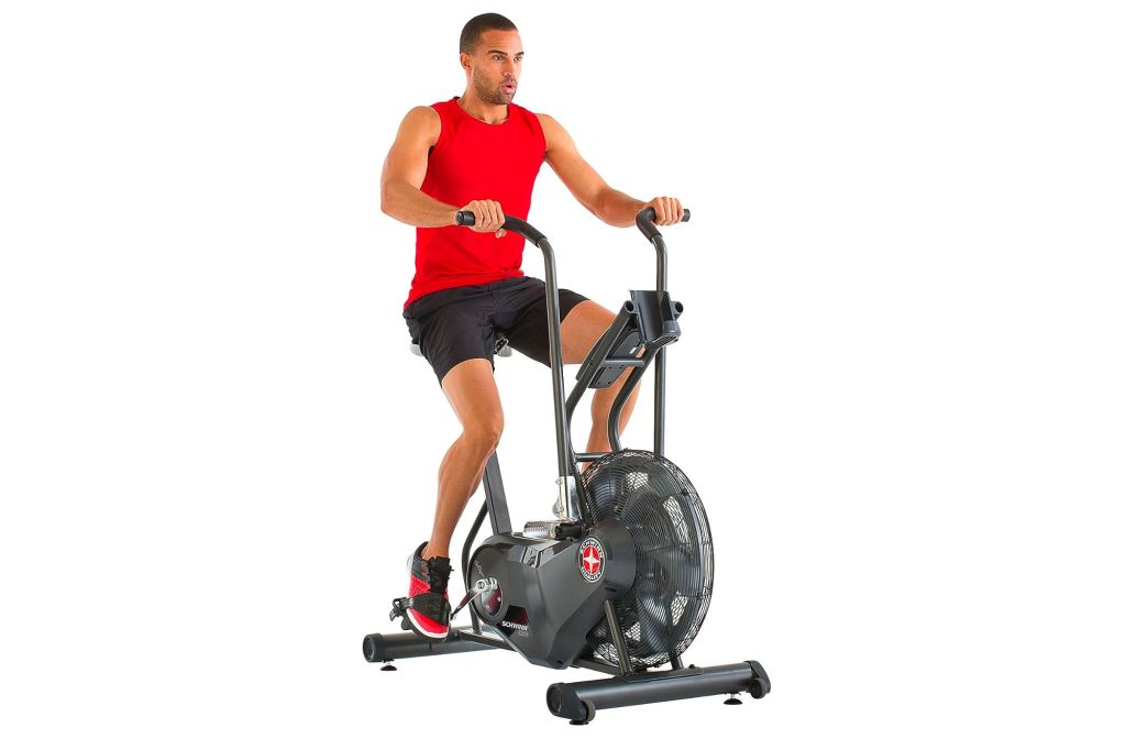 Exercise bike with man riding it.