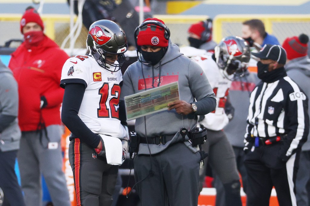 Nea head coach Byron Leftwich going over plays with Tom Brady