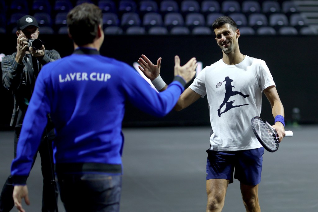 Roger Federer greets Novak Djokovic during Team Europe practice at the Laver Cup.