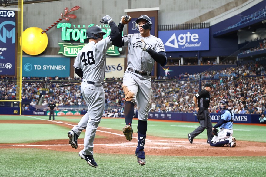 18 - Judge is congratulated by first baseman Anthony Rizzo after he hit a home run during the eighth inning against the Tampa Bay Rays at Tropicana Field, May 29.