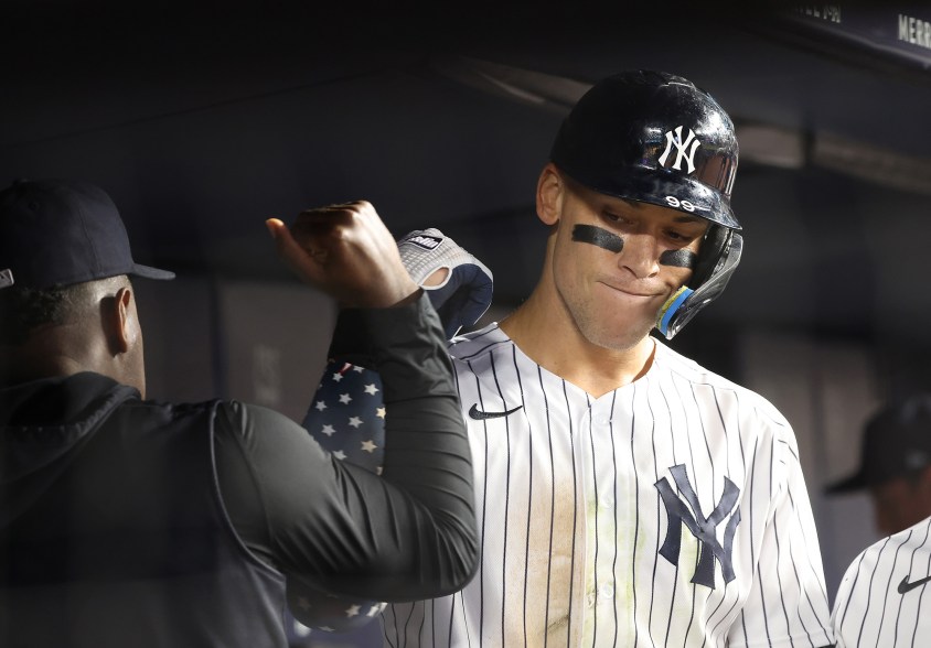 31 - Judge is greeted by starting pitcher Luis Severino in the dugout after he scores on a solo home run on July 14.