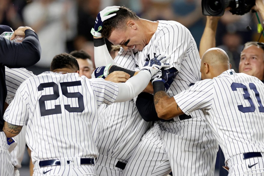 39 - Judge is congratulated by teammates after hitting a walk-off home run against the Kansas City Royals at Yankee Stadium July 28.