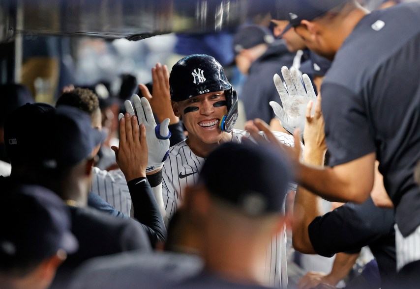 41 - Aaron Judge gets high fives from his teammates after a grand slam off of Kansas City Royals relief pitcher Scott Barlow in the eighth inning at Yankee Stadium in the Bronx, July 29.