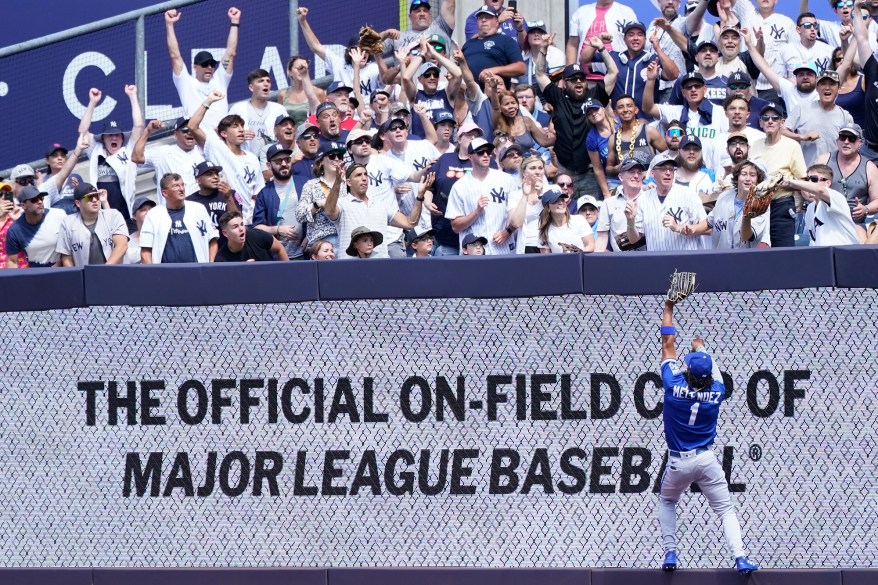 42 - Kansas City Royals' right fielder MJ Melendez reaches for the ball as a fan, right, catches New York Yankees' Aaron Judge's two-run home run during the second inning Saturday, July 30.