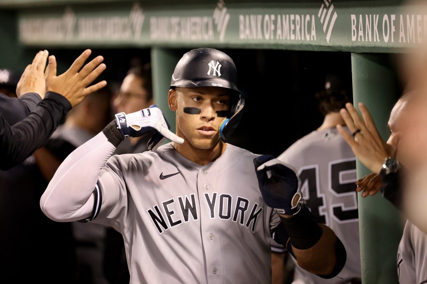 56 - Aaron Judge pretends to make a phone call while in the dugout, after hitting his 56th homer of the season in the 6th inning.