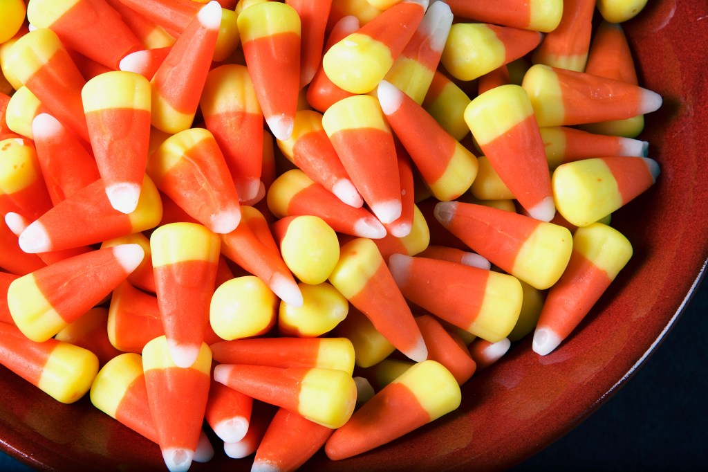 Candy corn in a red bowl.