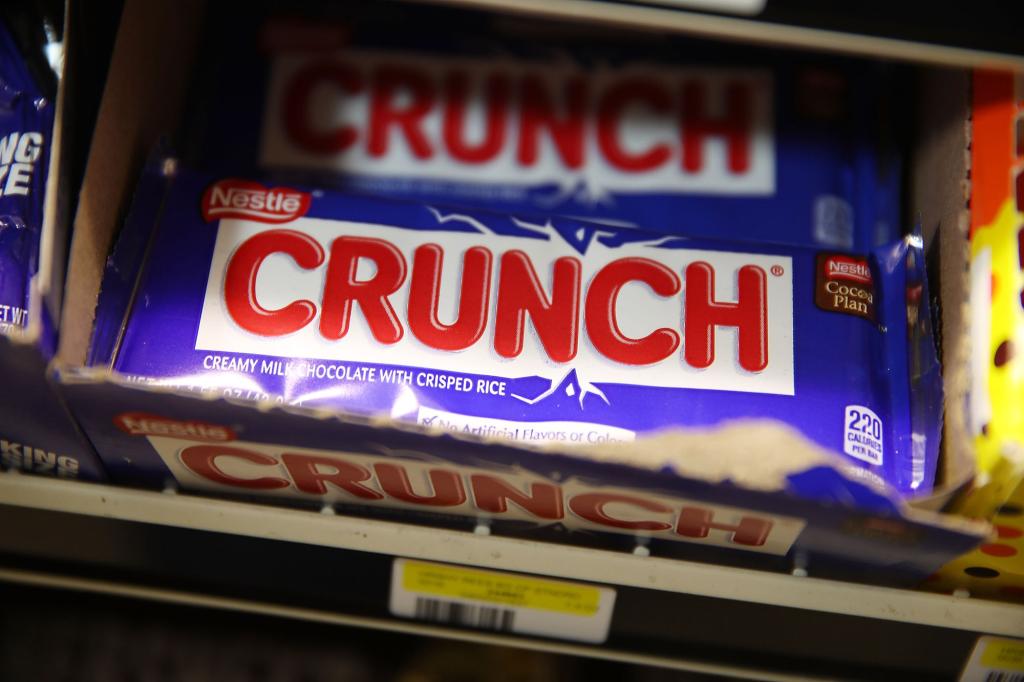 Nestle Crunch bars are seen on a store shelf.