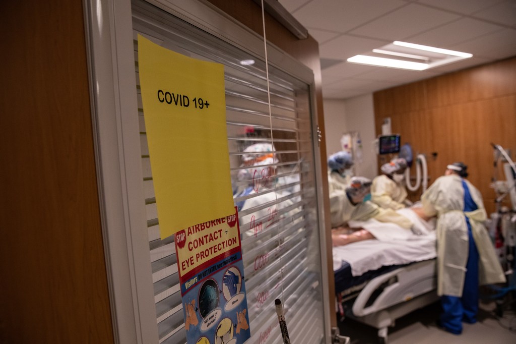 STAMFORD, CONNECTICUT - APRIL 24: (EDITORIAL USE ONLY) A "prone team," wearing personal protective equipment (PPE), prepares to turn a COVID-19 patient onto his stomach in a Stamford Hospital intensive care unit (ICU), on April 24, 2020 in Stamford, Connecticut. The civilian/military team, made up of physical and occupational therapists turns over COVID-19 patients to help their labored breathing and increase lung capacity. Stamford Hospital, like many across the US, opened additional ICUs and have been augmented by military medical personnel to deal with the heavy patient load. Stamford, with it's close proximity to New York City, has the highest number of coronavirus patients in Connecticut. 