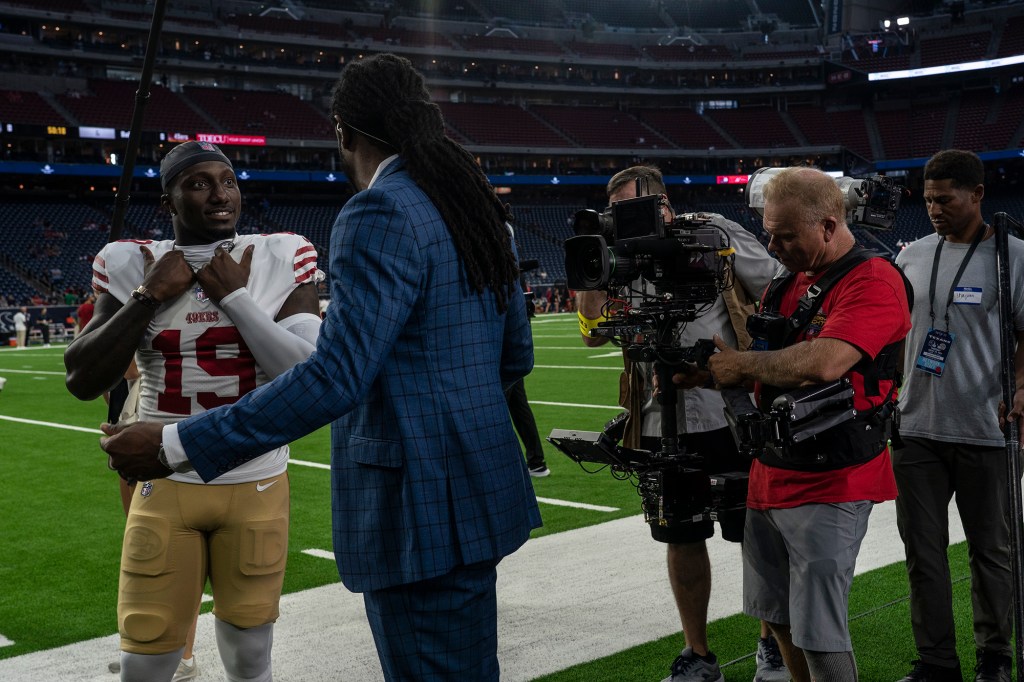 The Amazon production crew looks on as Richard Sherman interviews the 49ers' Deebo Samuel on Aug. 25, 2022.