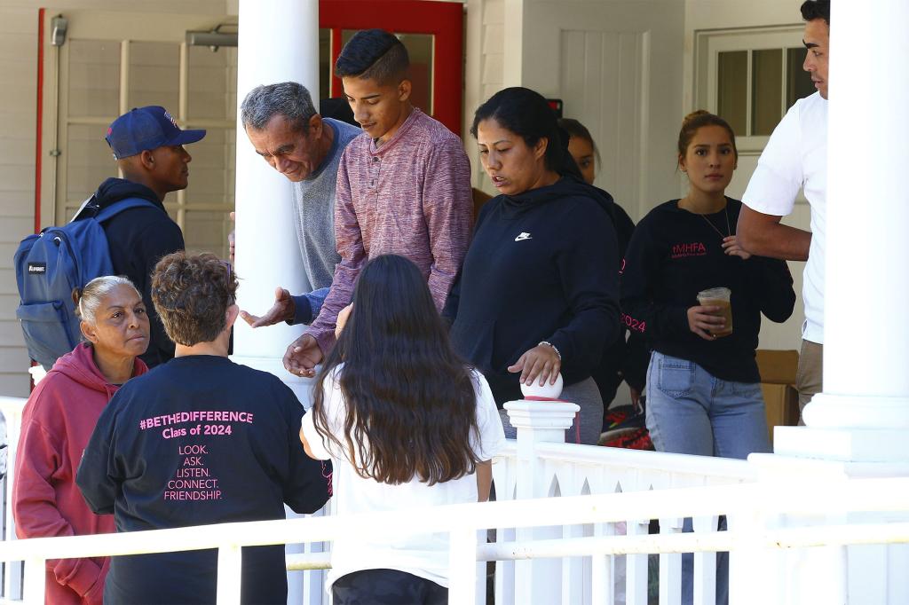 A group of nearly 50 migrants from Venezuela speak with volunteers at the parish house at St. Andrew's Episcopal Church in Edgartown, Massachusetts after being flown to Martha's Vineyard from Florida.