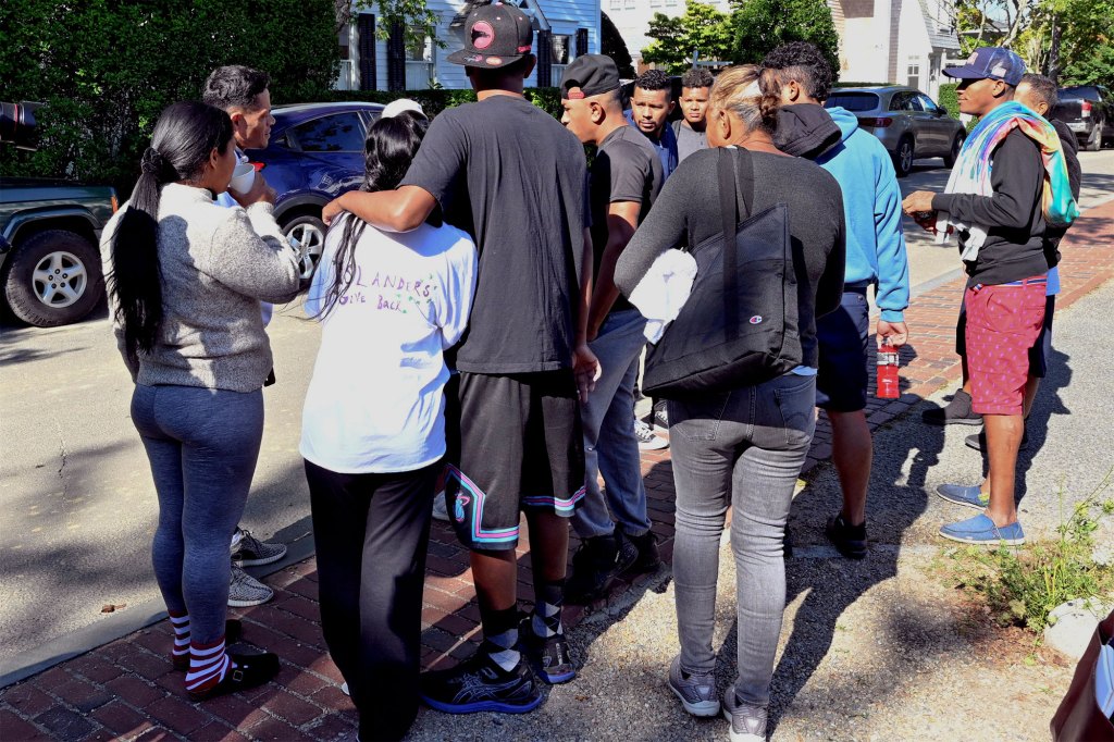 A group of immigrants gather outside St. Andrews Episcopal Church.