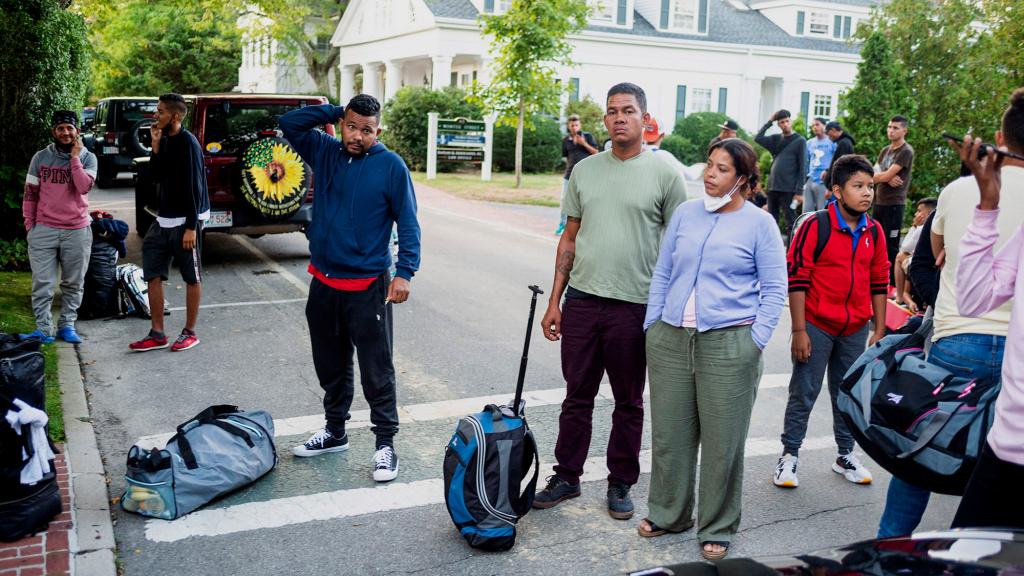 Migrants gather with their belongings outside St. Andrews Episcopal Church in Martha's Vineyard.