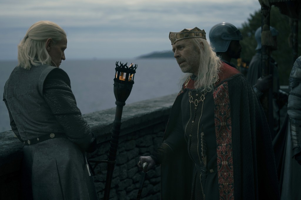 Daemon Targaryen (Matt Smith) and his brother King Viserys (Paddy Considine) talk on a veranda. 