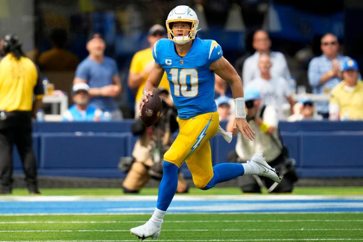 Quarterback Justin Herbert #10 of the Los Angeles Chargers scrambles against the Las Vegas Raiders during an NFL game at SoFi Stadium in Inglewood, Calif., on Sunday, September 11, 2022.