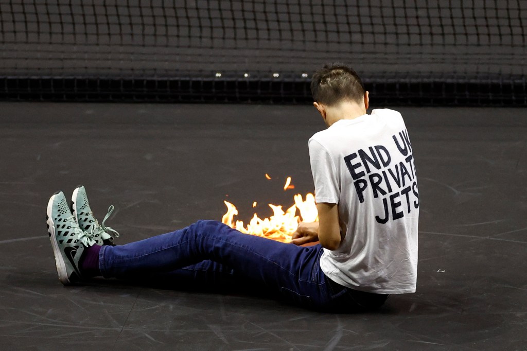 A protester sets himself on fire at the Laver Cup in London.