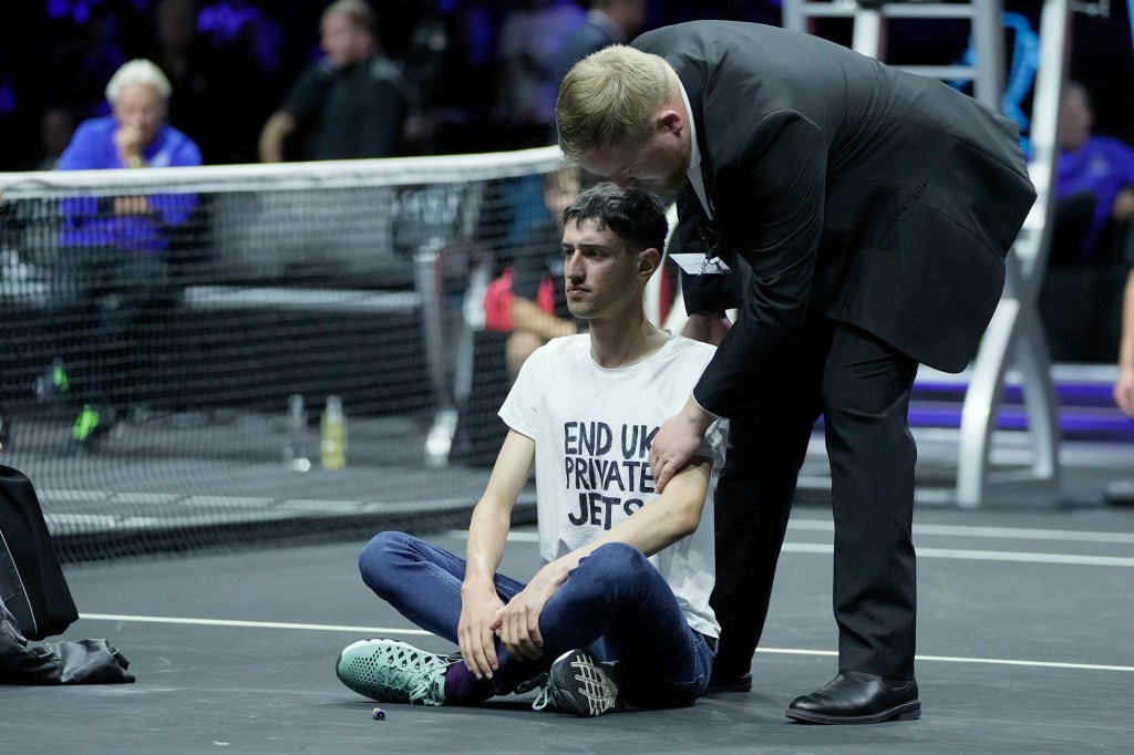 The protester gets dragged out by security.