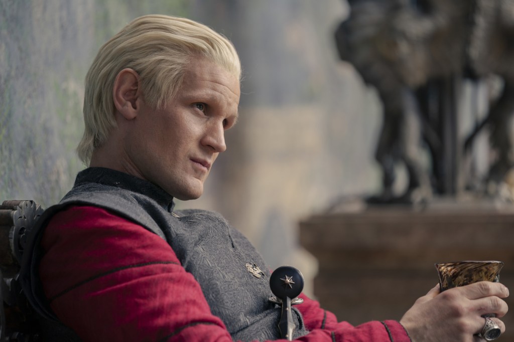 Matt Smith smirking with blonde hair. 