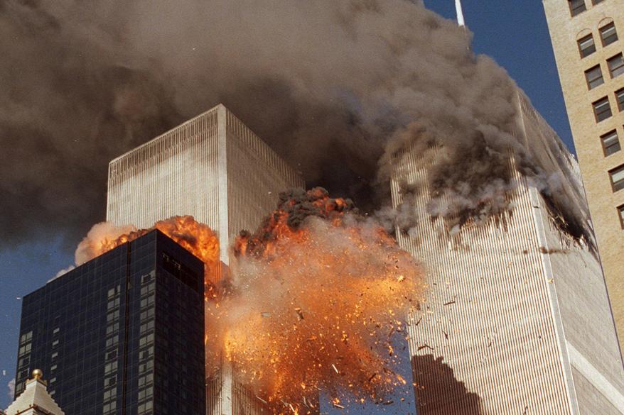 In this September 11, 2001 file photo, smoke billows from World Trade Center Tower 1 and flames explode from Tower 2 as it is struck by American Airlines Flight 175, when terrorists crashed hijacked airliners into the buildings.