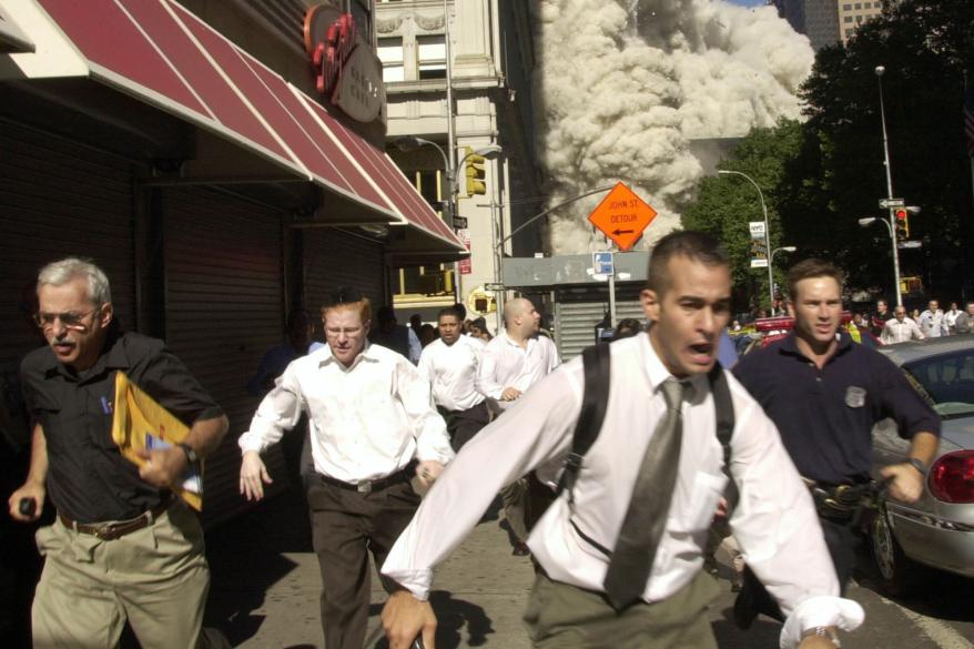 People run from the collapse of one of the twin towers of New York's World Trade Center in this Sept. 11, 2001, file photo.