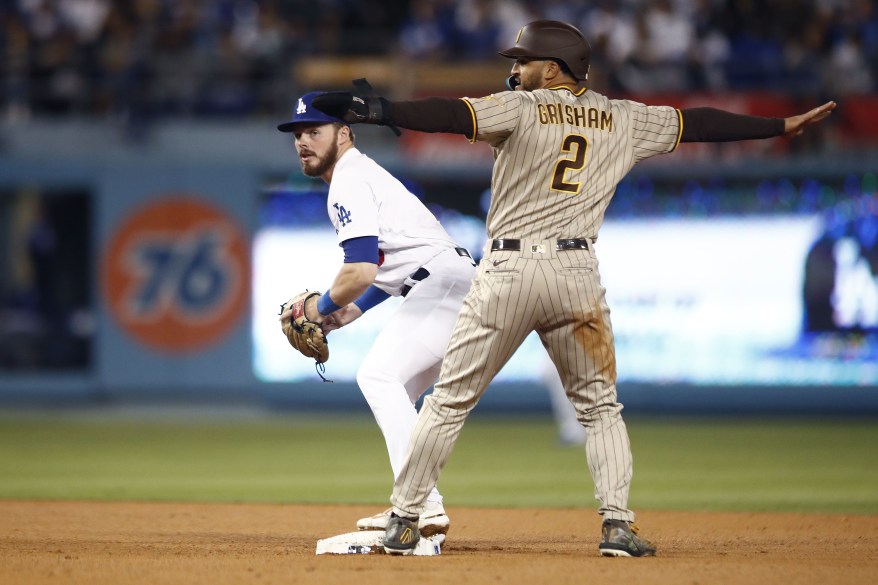 San Diego Padres Trent Grisham signals he is safe, as he beat the tag during game two of the MLB Playoff's in Los Angeles, Calif. on Oct. 12, 2022.