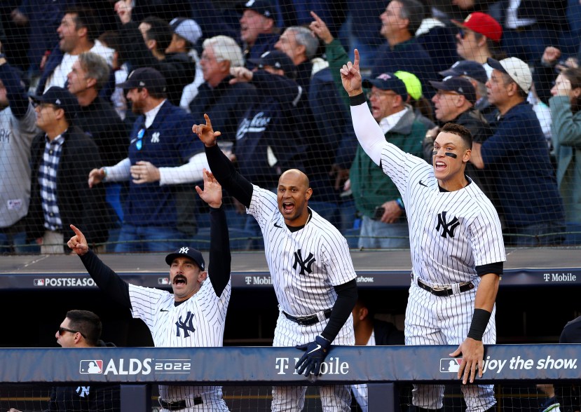 Matt Carpenter #24, Aaron Hicks #31 and Aaron Judge #99 of the New York Yankees react to Giancarlo Stanton's three-run home run against the Cleveland Guardians during the American League Division Series at Yankee Stadium on Oct. 18, 2022.