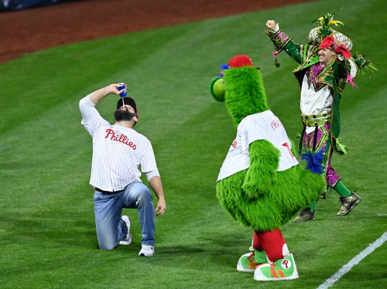 Philadelphia Eagles tight end Jason Kelce chugs a beer during NLCS Game 3 on Oct. 21, 2022 in Philadelphia.