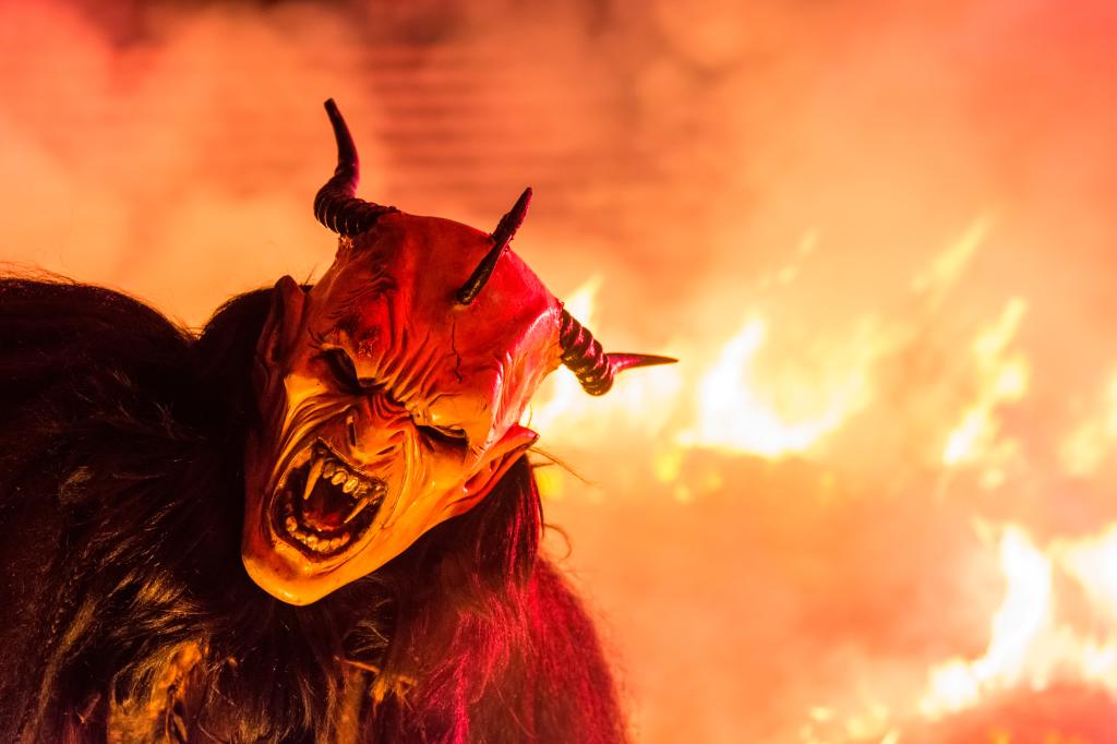 A person wearing a Krampus devil mask