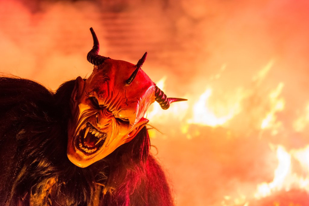 A person wearing a Krampus devil mask