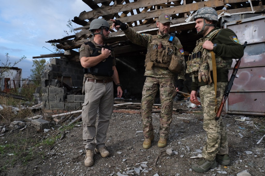 Seggos (left) met with Territorial Defense Forces on the front lines, near the Russian border.