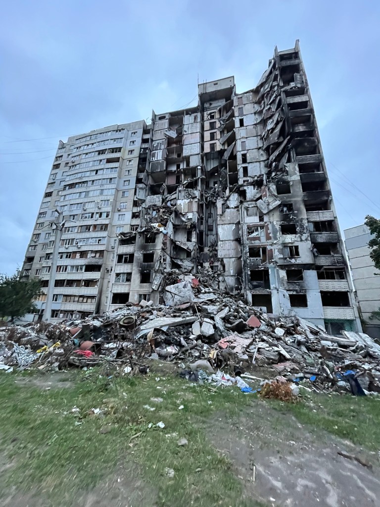 "You couldn't see it and not think that every single home that had been damaged was a war crime," said Seggos of buildings like this destroyed apartment building he photogrphed in Kharkiv.