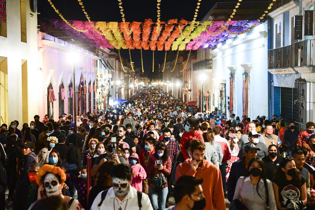 Oaxaca De Juarez: Passers-by walk along a street on the Day of the Dead.