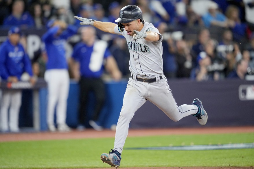 Seattle Mariners Mitch Haniger celebrates after crossing home plate in Seattle's come-from-behind victory on Oct. 8, 2022.