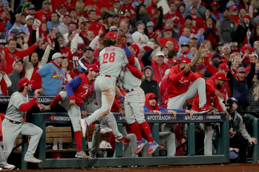 Alex Bohm (#28) hugs Edmundo Sosa after Sosa caught the final out to send the Phillies to the NLDS on Oct. 8, 2022.