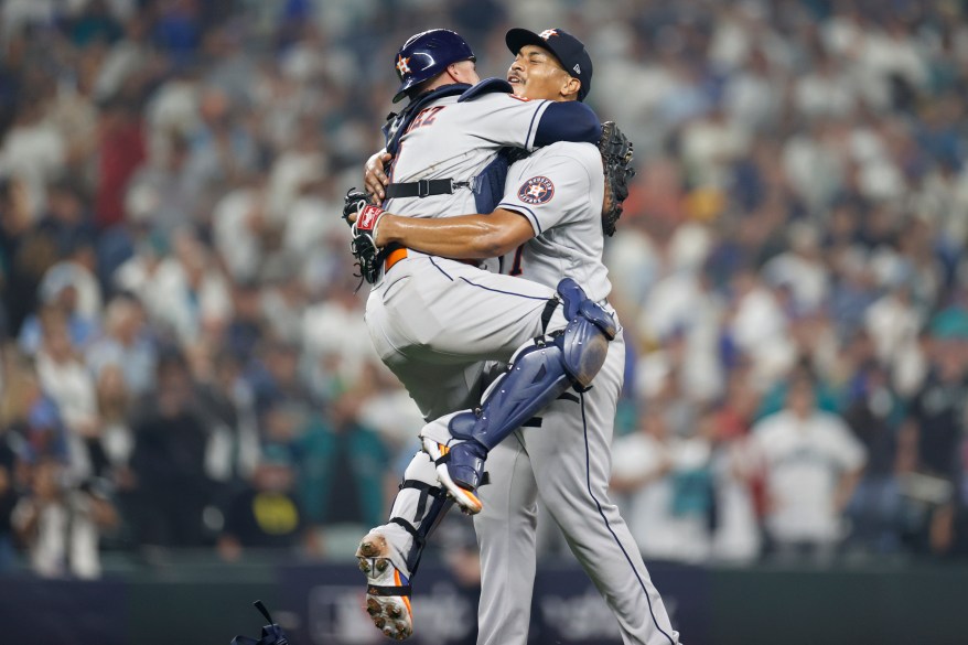 Christian Vazquez jumps into the arms of Luis Garcia, after the Astros defeated the Mariners to head to the ALCS on Oct. 15, 2022.