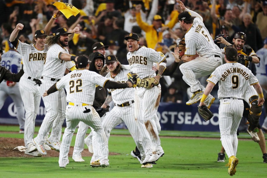 The San Diego Padres celebrate after defeating the Dodgers in Game 4 of the NLDS to head to the NLCS on Oct. 15, 2022.