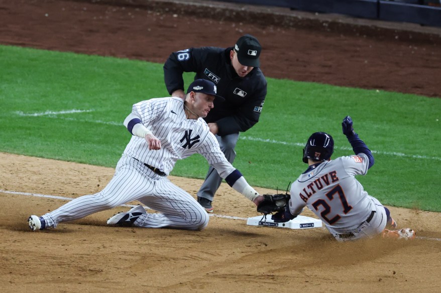 Josh Donaldson of the New York Yankees tags out Jose Altuve #27 of the Houston Astros at third base in the ninth inning in game four of the AL Championship Series on Oct. 23, 2022 in New York City.